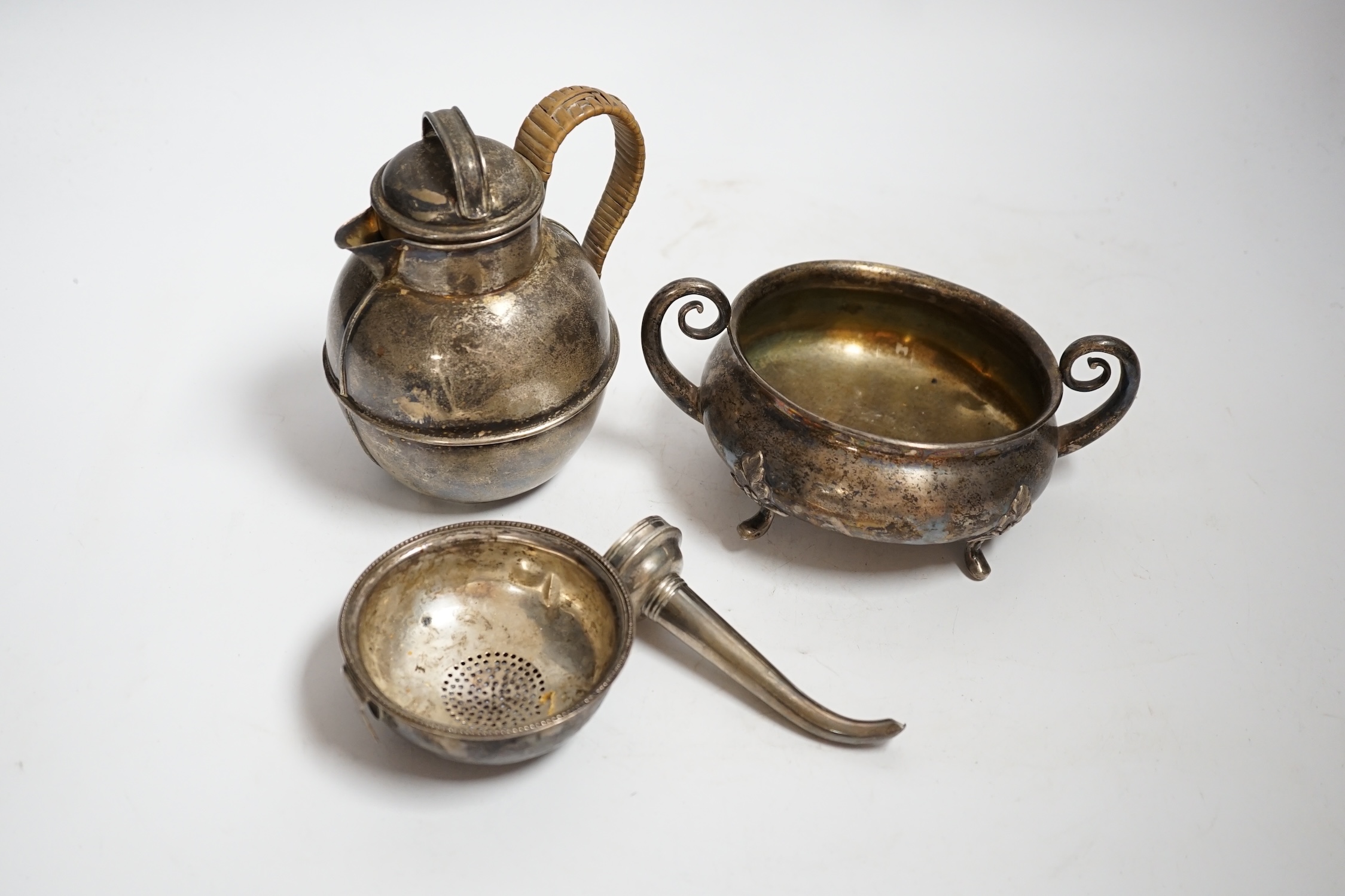 An Edwardian silver 'Guernsey' milk can, Mark Willis & Son, Sheffield, 1904, height 13cm, a George III silver wine funnel by Benjamin Montague? and a continental white metal two handle bowl (a.f.) gross weight 14.3oz.